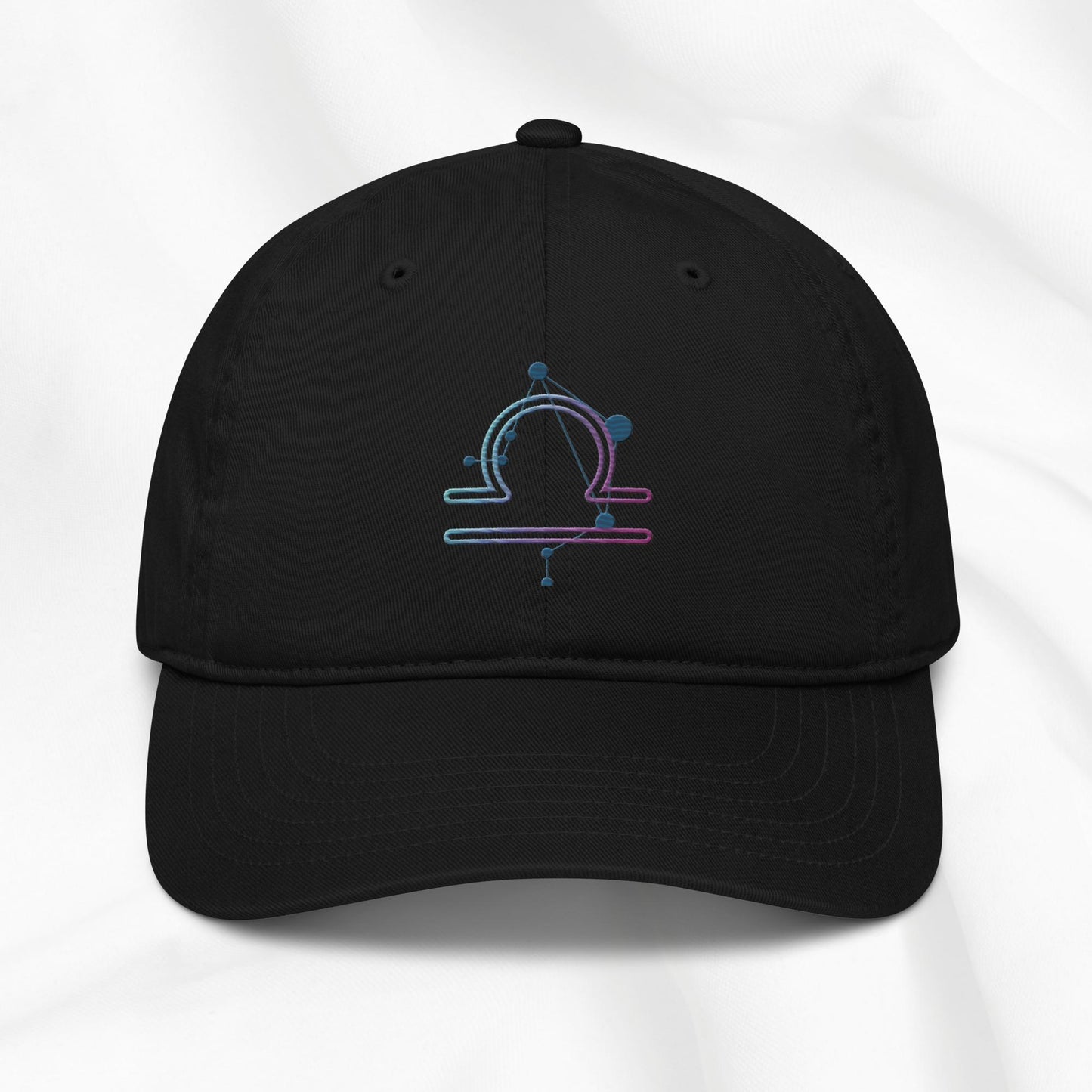 Black organic cotton baseball cap with an embroidered libra zodiac design on a white background