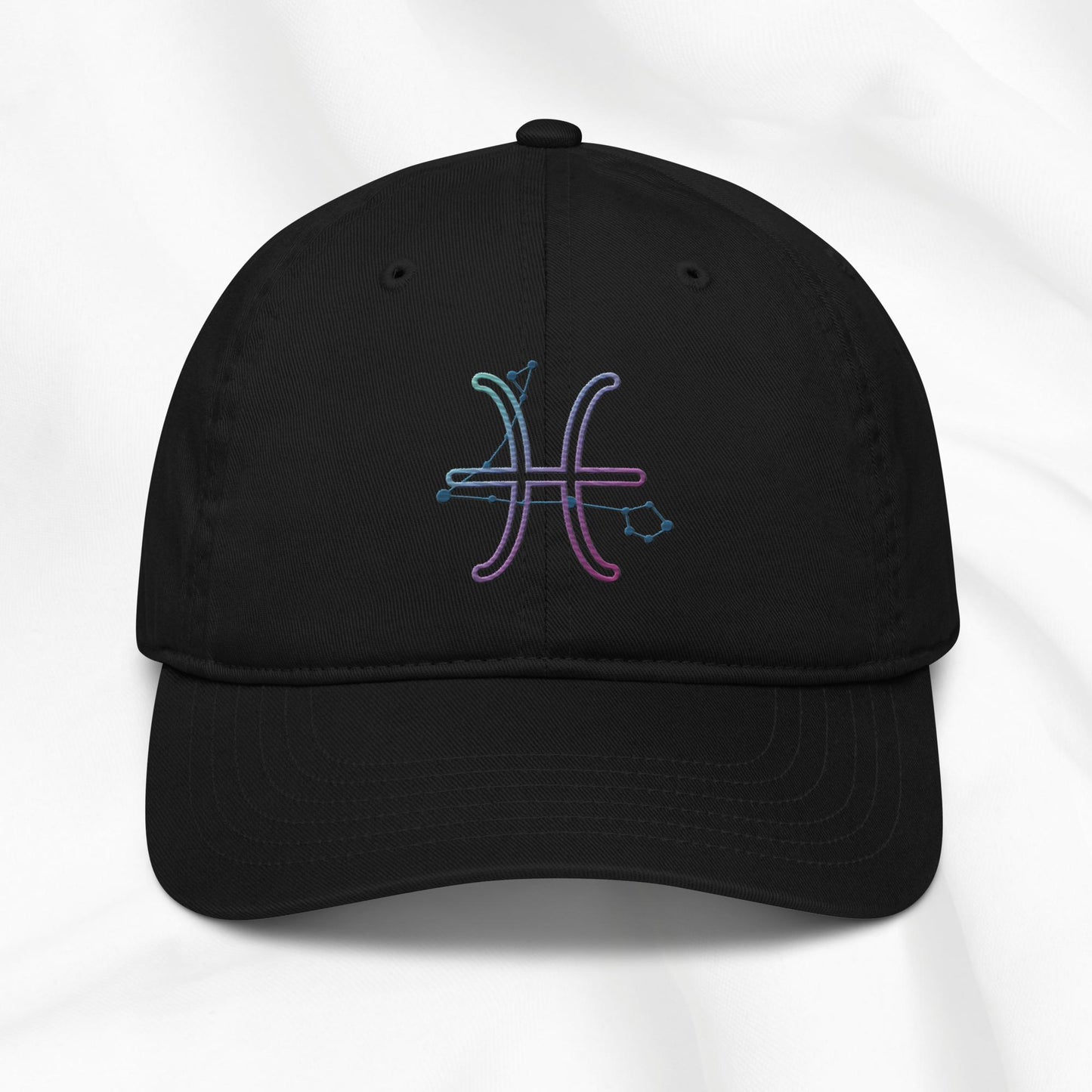Black organic cotton baseball cap with an embroidered Pisces zodiac design on a white background