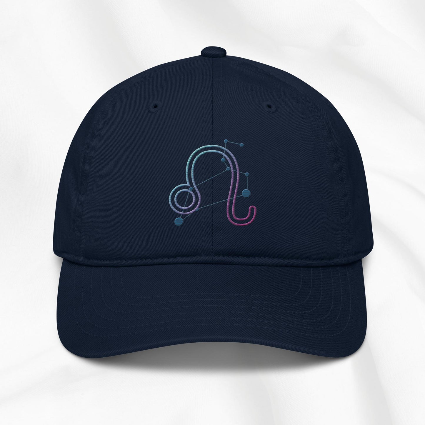 Navy organic cotton baseball cap with embroidered Leo zodiac design on a white background