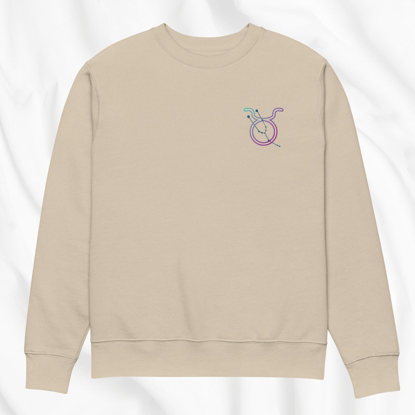 Beige sweatshirt with a Taurus zodiac design on a white background