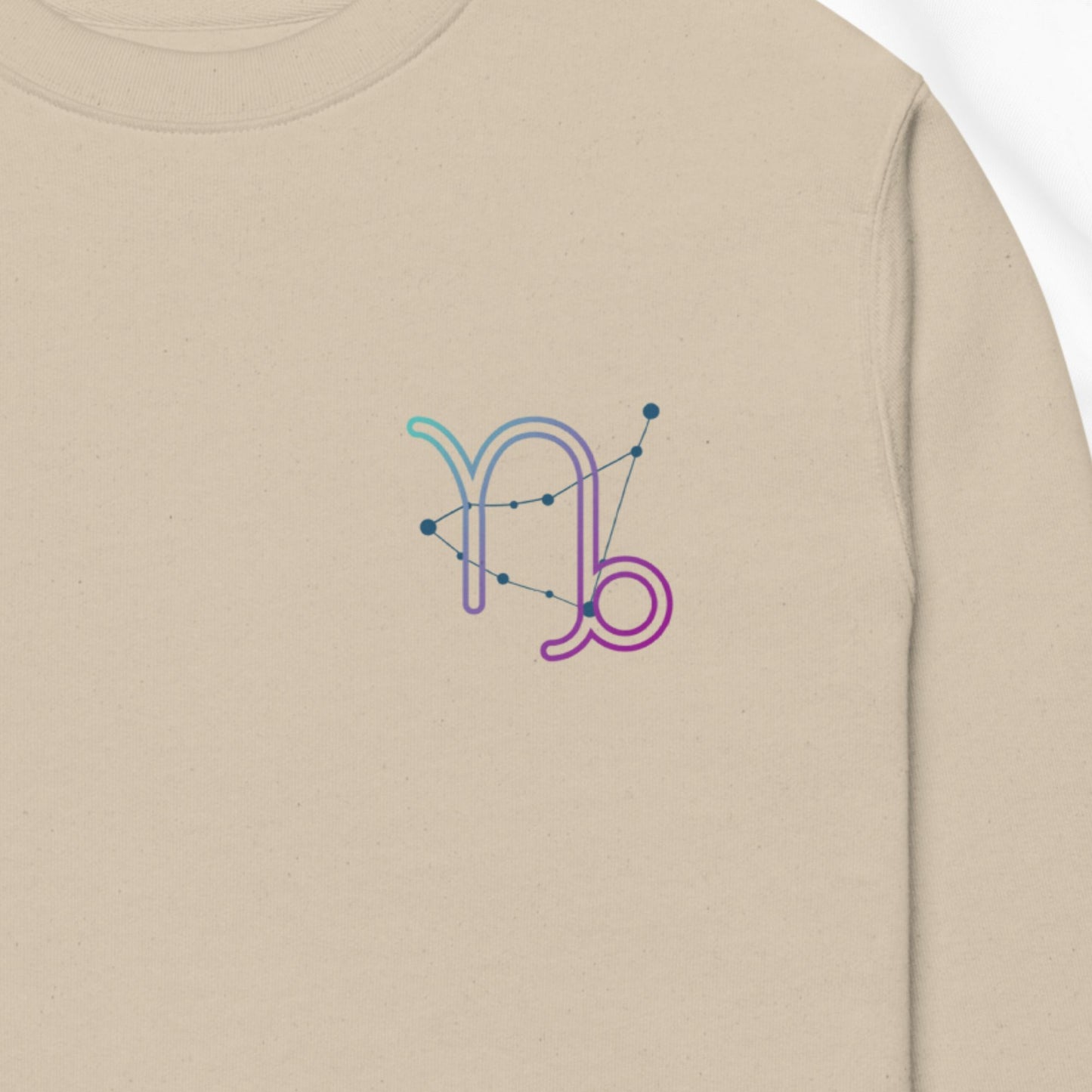 Beige sweatshirt with a colorful Capricorn design on the chest.