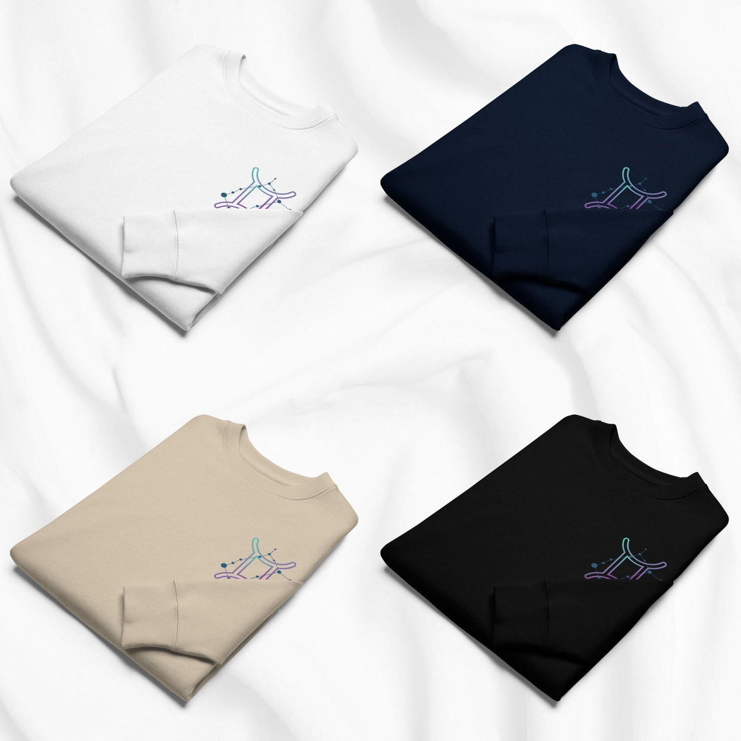 Four folded sweatshirts in different colors with printed zodiac designs on a white background
