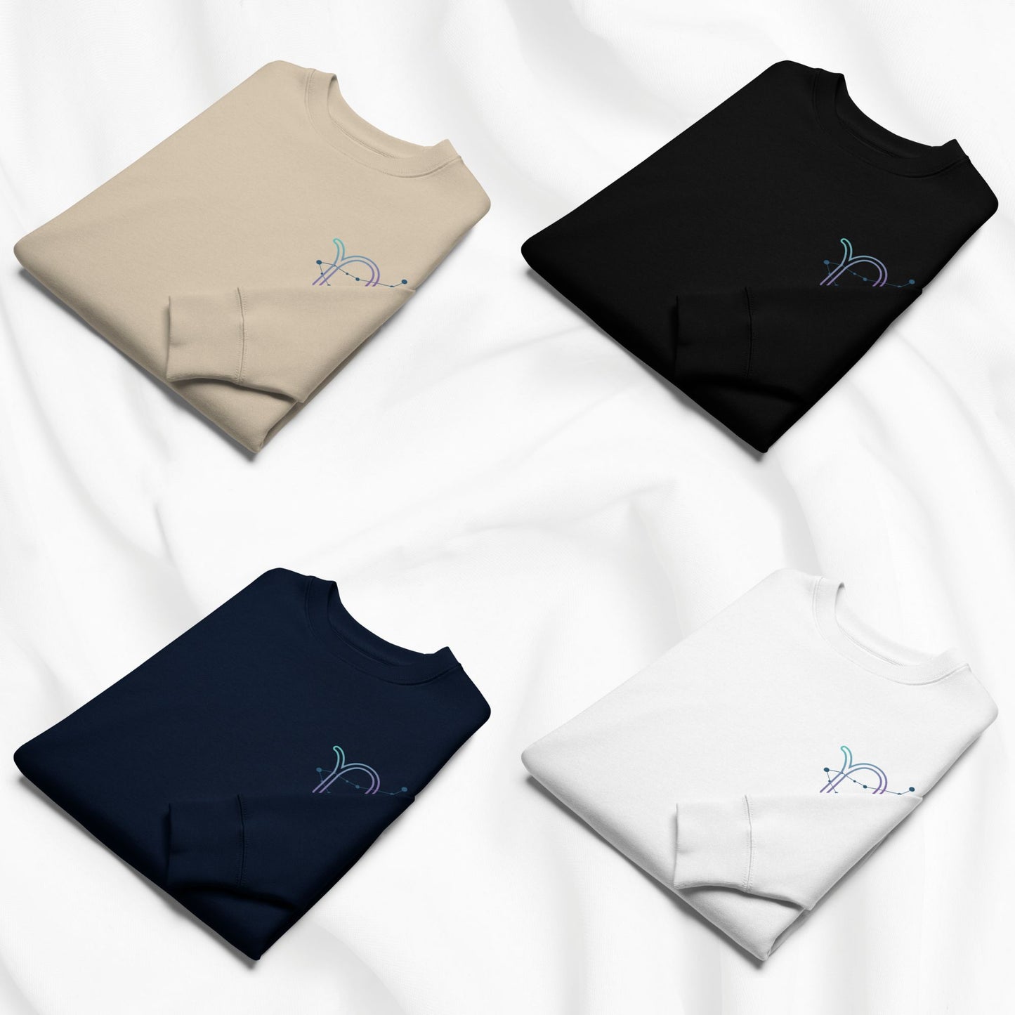 Four folded sweatshirts in beige, black, navy, and white on a white background