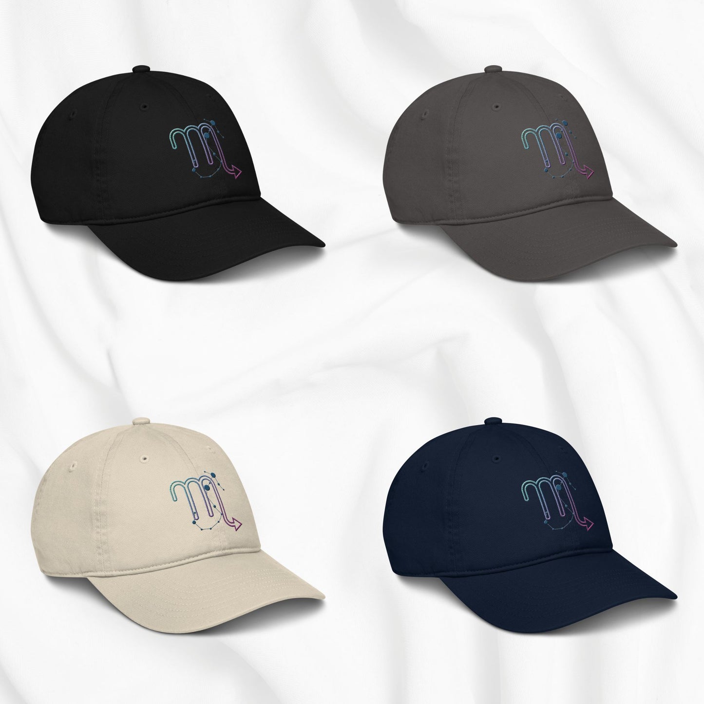 Four baseball caps in black, gray, beige, and navy with embroidered scorpio zodiac designs on a white background.