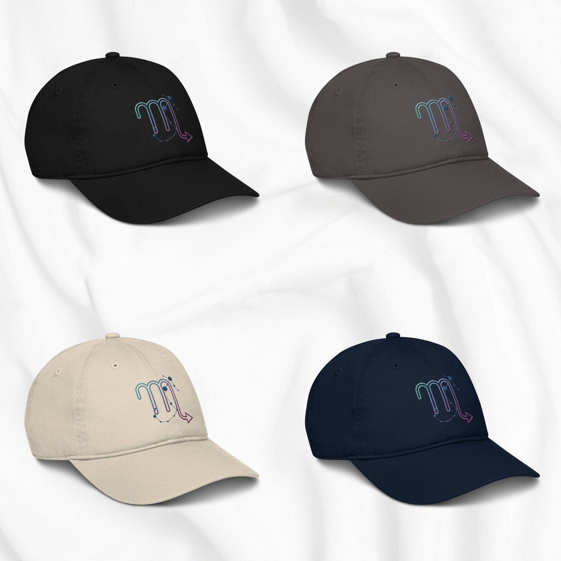 Four baseball caps in black, gray, beige, and navy with embroidered scorpio zodiac designs on a white background.