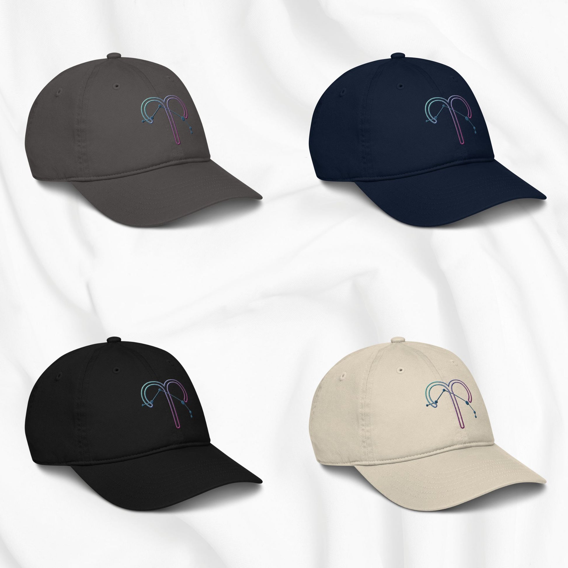 Four baseball caps in different colors with an embroidered Aries zodiac design on a white background
