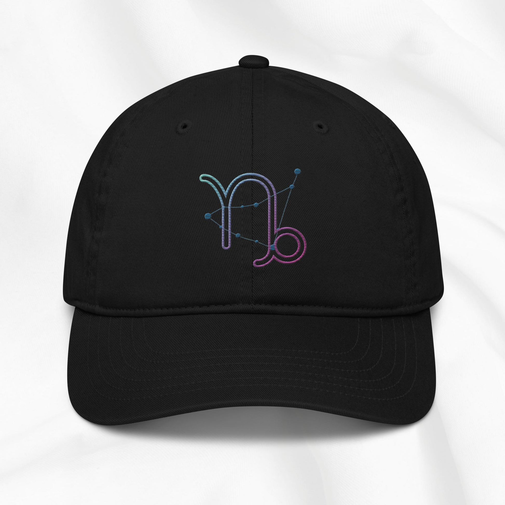 Black organic cotton baseball cap with embroidered capricorn graphic on white background