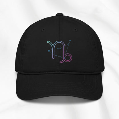 Black organic cotton baseball cap with embroidered capricorn graphic on white background