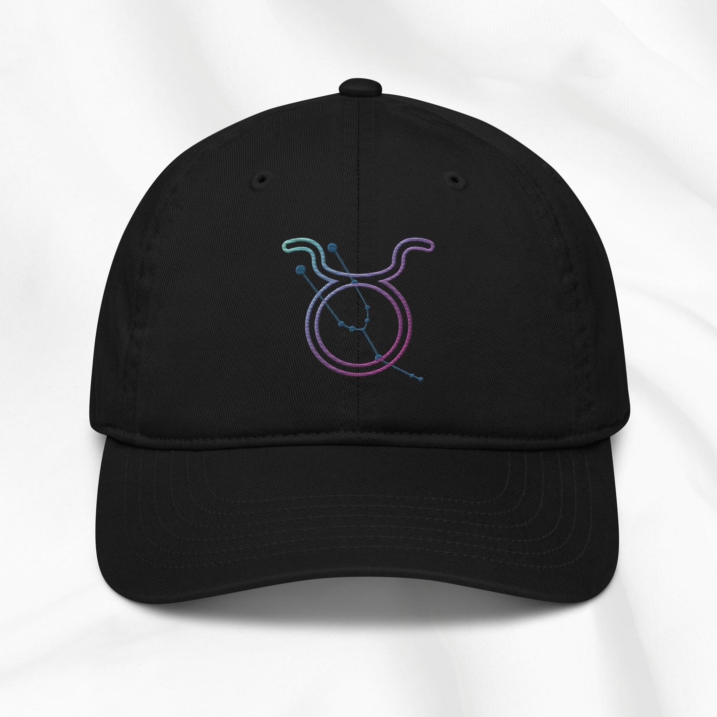 Black baseball cap with a colorful embroidered Taurus zodiac symbol on a white background