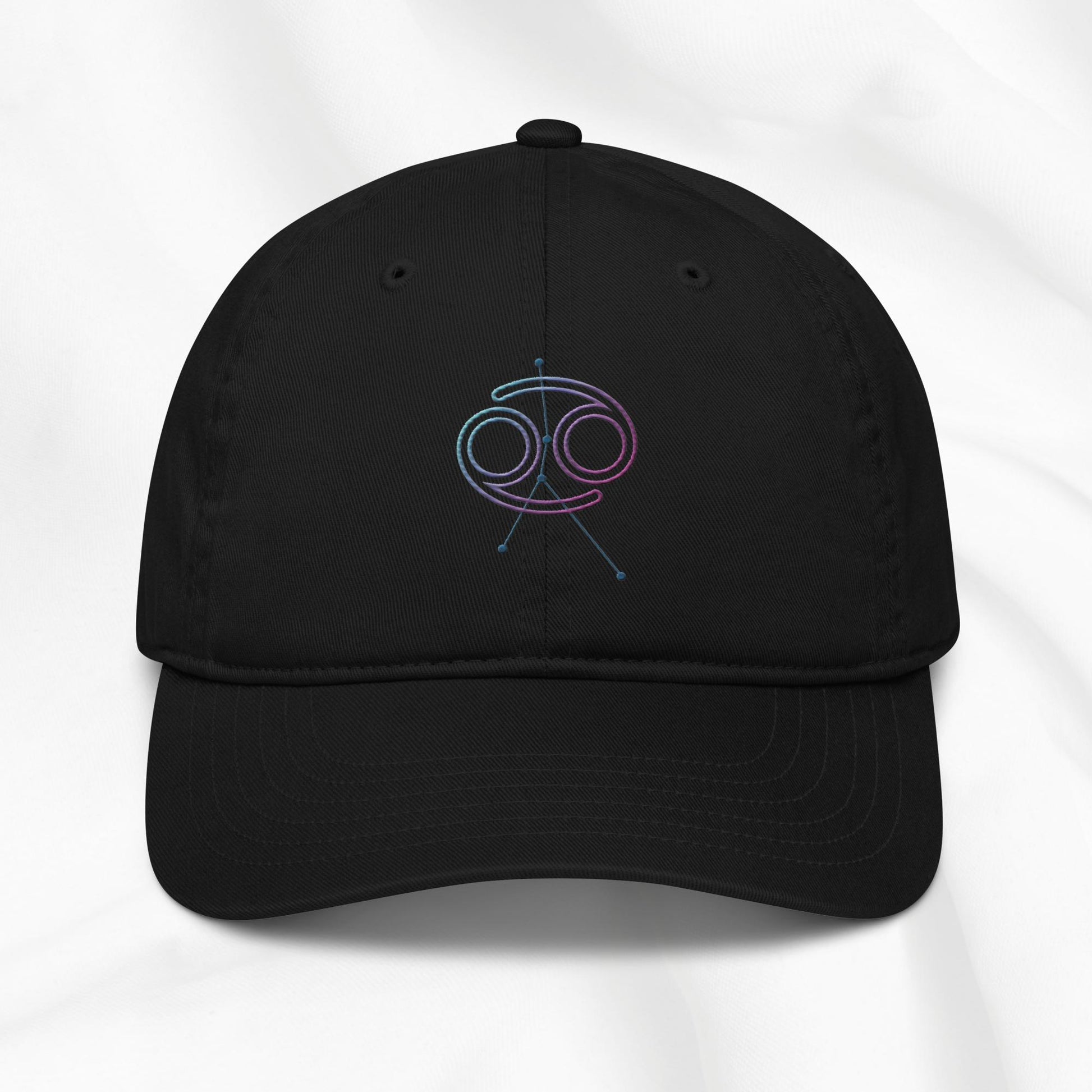 Black organic cotton baseball cap with embroidered Cancer zodiac graphic on a white background