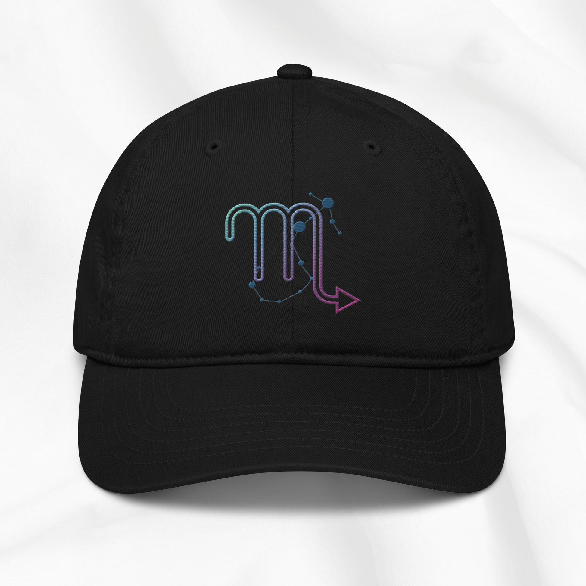 Black organic cotton baseball cap with an embroidered scorpio zodiac graphic on a white background. 