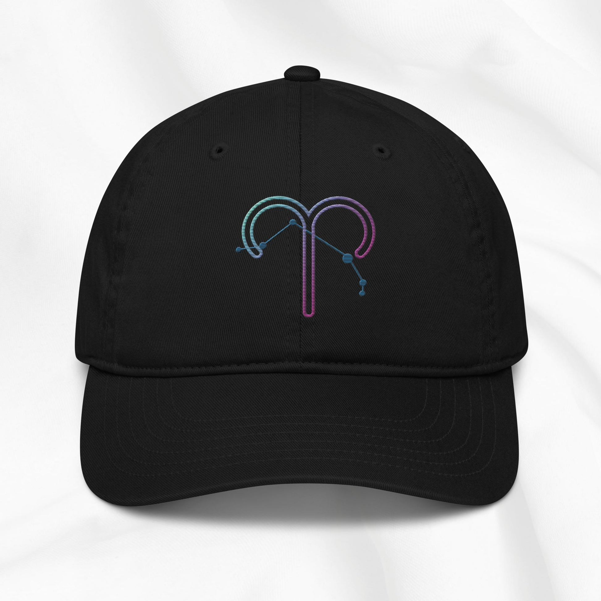 Black organic cotton baseball cap with an embroidered Aries zodiac design on a white background 