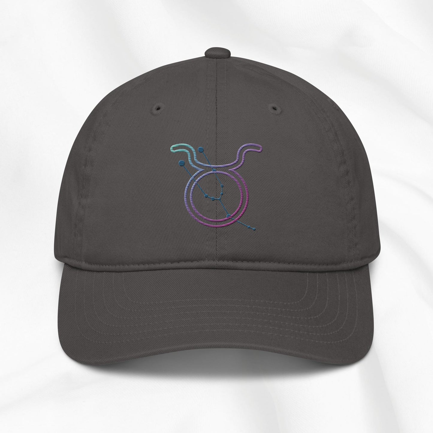 Gray baseball cap with a colorful embroidered Taurus zodiac symbol on a white background