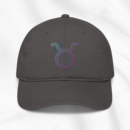 Gray baseball cap with a colorful embroidered Taurus zodiac symbol on a white background
