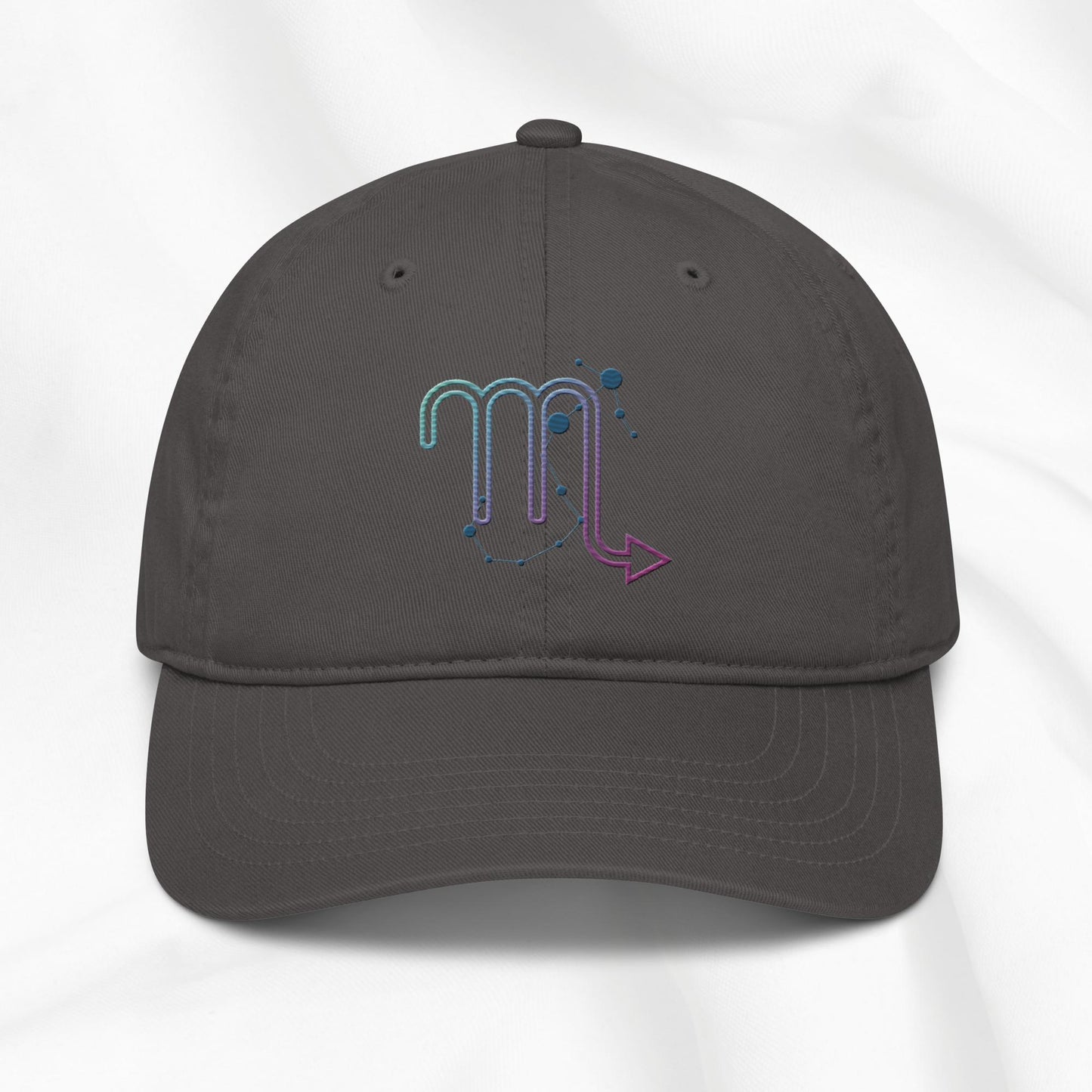 Gray organic cotton baseball cap with an embroidered scorpio zodiac graphic on a white background. 