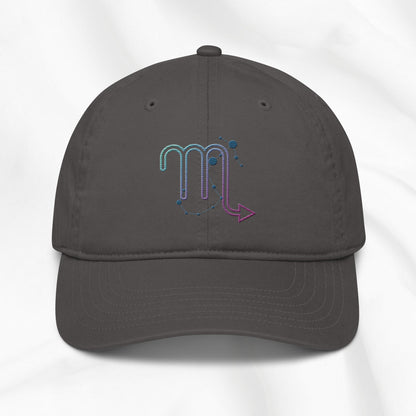 Gray organic cotton baseball cap with an embroidered scorpio zodiac graphic on a white background. 