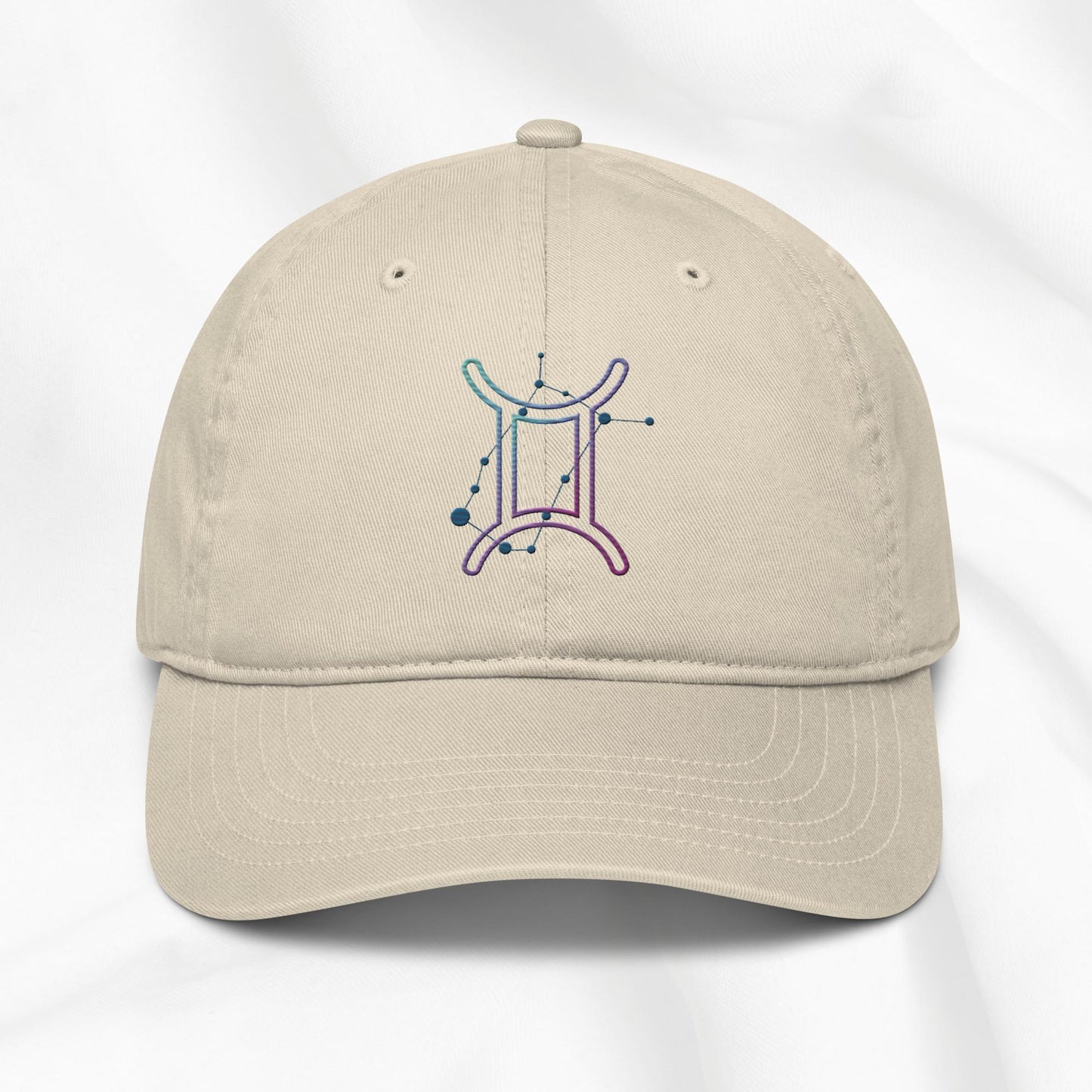 beige organic cotton baseball cap with embroidered gemini graphic on white background