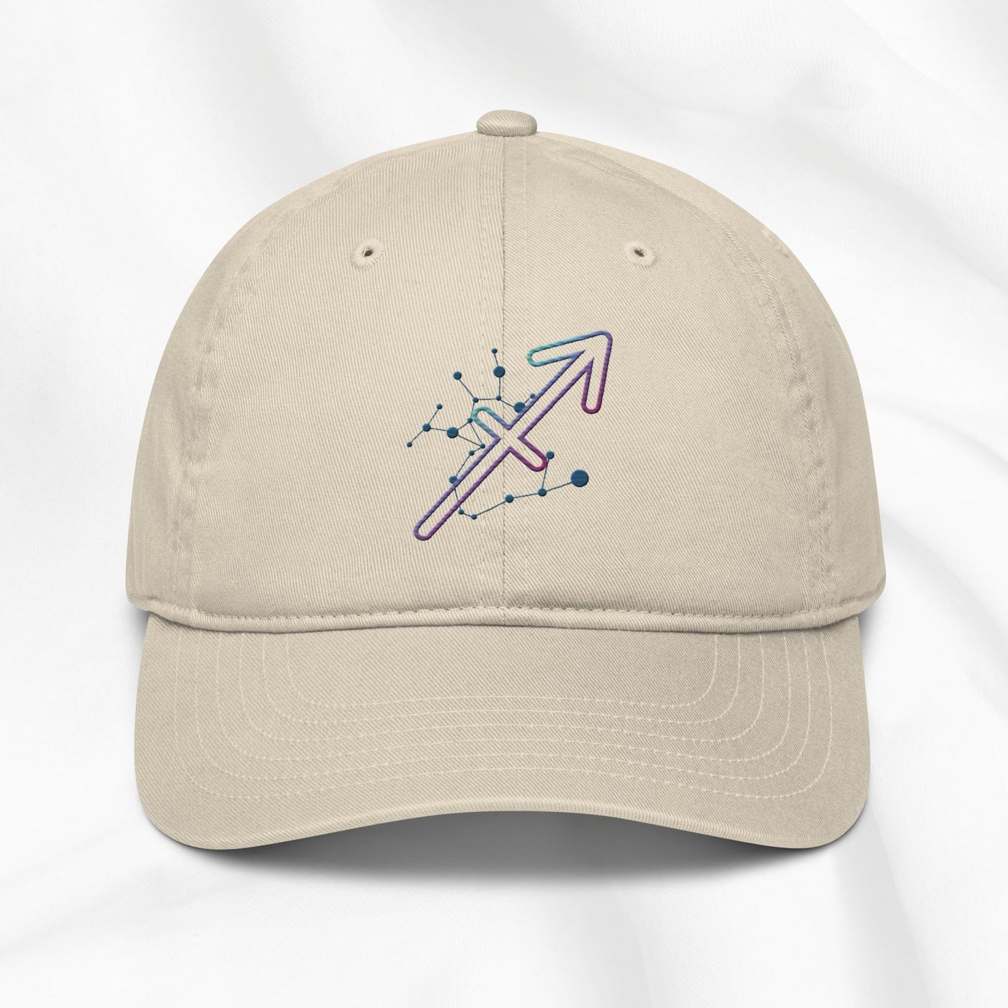 Beige organic cotton baseball cap with Sagittarius zodiac embroidered graphic on a white background.