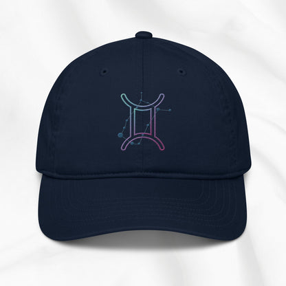 Navy organic cotton baseball cap with embroidered gemini graphic on white background