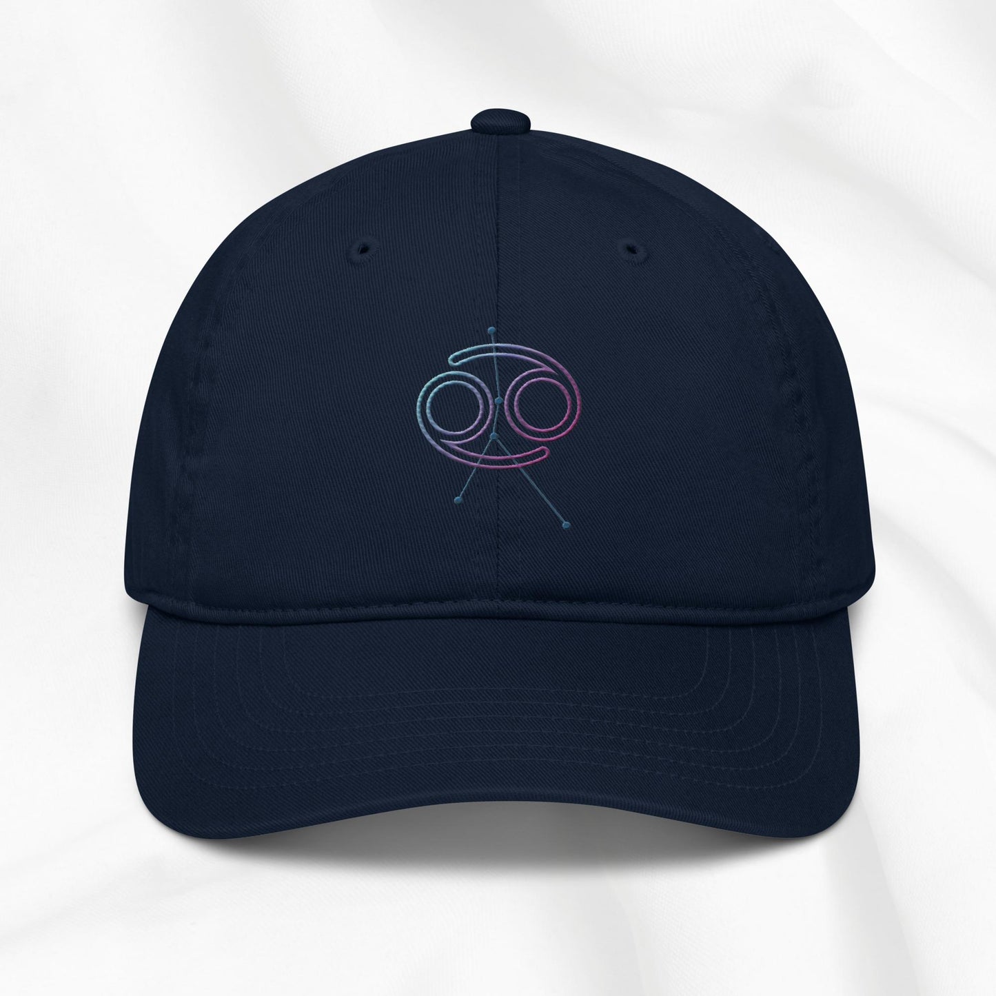 Navy organic cotton baseball cap with embroidered Cancer zodiac graphic on a white background