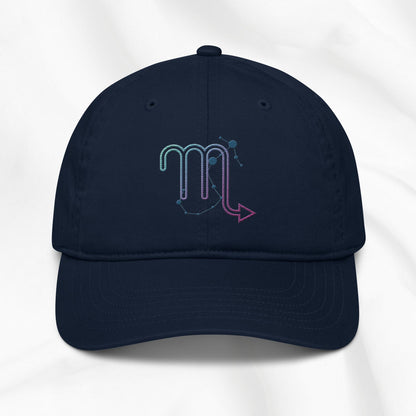 Navy organic cotton baseball cap with an embroidered scorpio zodiac graphic on a white background. 
