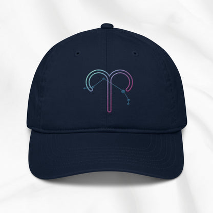 Navy organic cotton baseball cap with an embroidered Aries zodiac design on a white background 