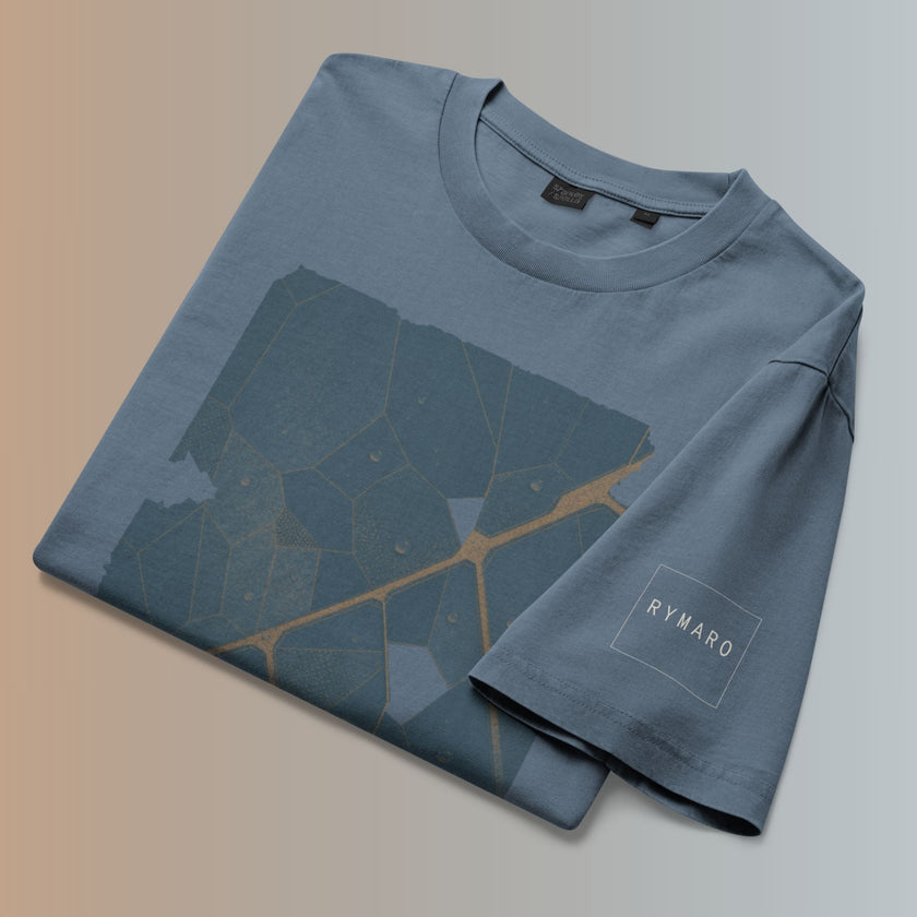 Folded Deep Teal Veinwork T-shirt showing the front artwork and subtle RYMARO sleeve logo.
