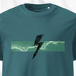 Teal t-shirt with a graphic design of a lightning bolt on a white background