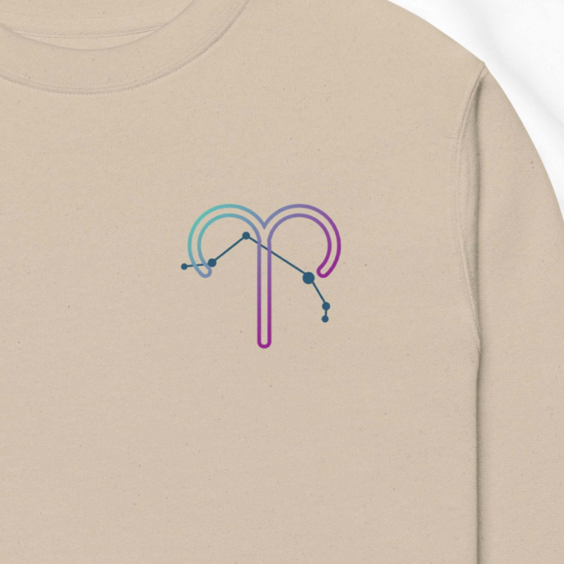 Beige sweatshirt with a colorful constellation design on the chest.