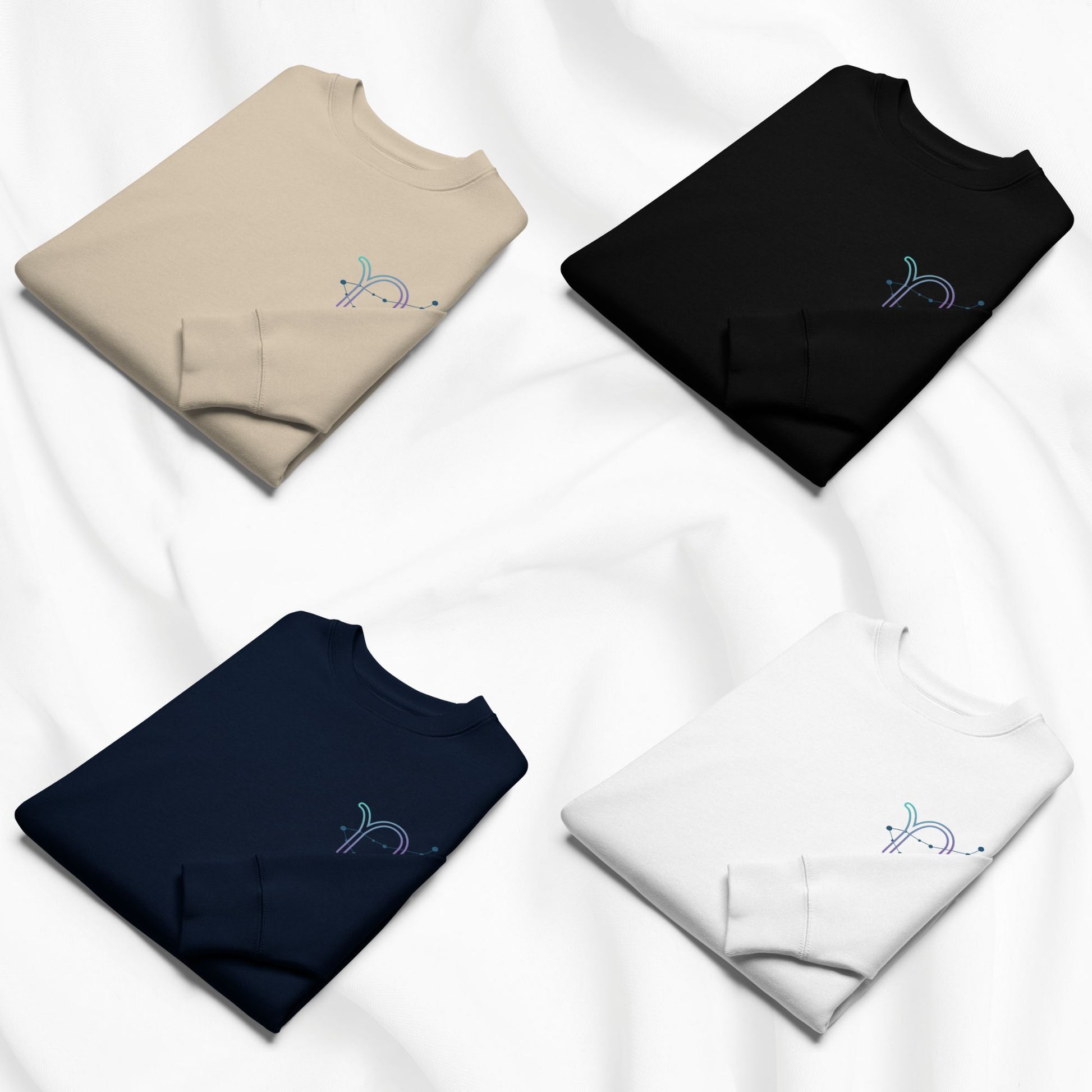 Four folded sweatshirts in beige, black, navy, and white on a white background